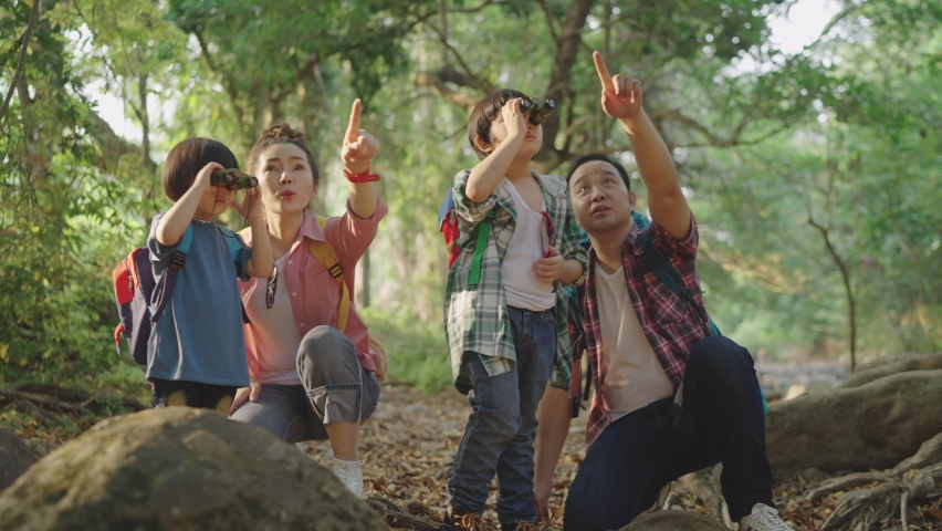 Slow-motion. The Asian family brought two sons Hiking using binoculars For education Learn nature on vacation at the nature study center. Royalty-Free Stock Footage #1070027518