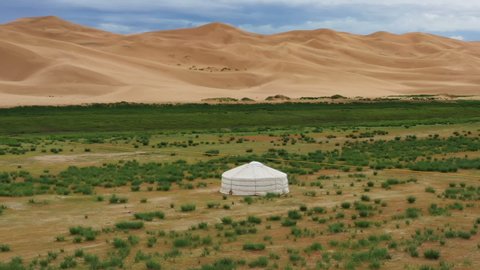 Aerial around view on lonely yurt near the sand dunes in the Gobi Desert, Mongolia