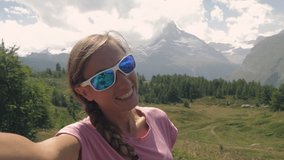 Young woman on summer hike takes cool video selfies 