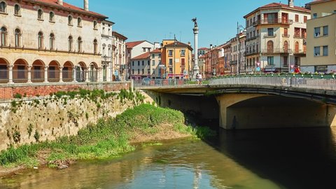 VICENZA, ITALY - APRIL 22 2018: Bridge of Angels and Square XX September with winged angel and Magre Angaran Palace on Bacchiglione River in historic center of Vicenza, Italy.