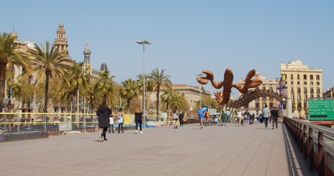 Barcelona Spain 03 30 2021- Columbus passage (Paseo de Colon) in Barcelona. View of shrimp statue (Sculpture La Gamba) and face of Barcelona statue