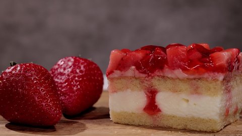 Fresh strawberry cake with cream in close-up - studio photography