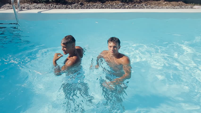 Beautiful Guys Fooling Around Splashing Pool Stock Footage Video