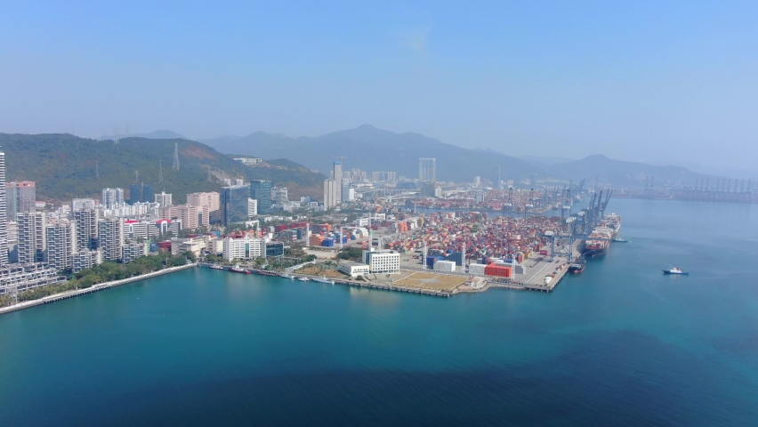 Shenzhen commercial Port terminal with docked Ships and Container yard, Aerial view.