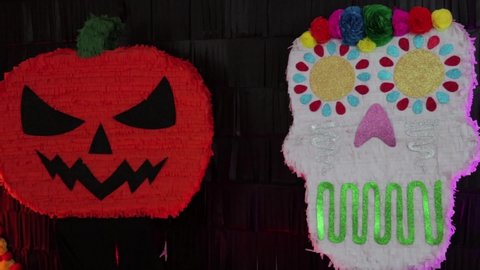 Halloween and día de muertos (day of the dead) decoration. Pumpkin and clavera (skull).
