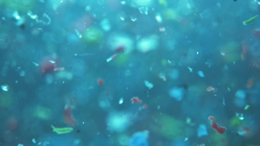 microplastics in water. plastic fragments or particles in ocean. ocean pollution by single-use plastics. environment, ecology, water, earth, slow motion Royalty-Free Stock Footage #1070061805