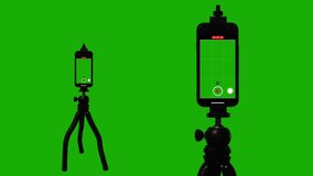 Vertical Smartphone Video Recorder Viewfinder Mounted On Tripod, Green Screen. Isolated smartphones mounted on a tripod is recording video on a green screen background for replacement