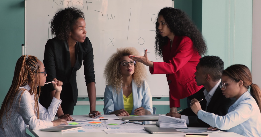 Two African serious female project leaders and team brainstorming gather in office boardroom. Negotiations meeting, briefing in company, businesspeople make solution. Management and leadership concept | Shutterstock HD Video #1070073703