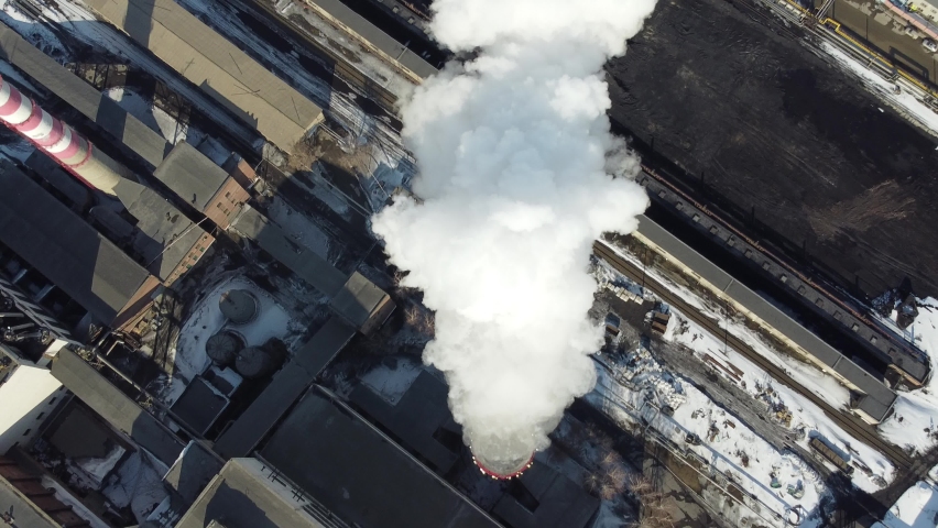 white smoke coming from a huge chimney of the thermal power plant flies towards the big city of Novosibirsk