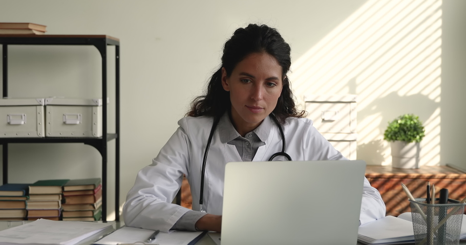 Unhappy young female doctor looking at laptop screen, thinking of problem solution, severe illness diagnosis or bad health test results, worrying about mistake or feeling under pressure in clinic. Royalty-Free Stock Footage #1070084752