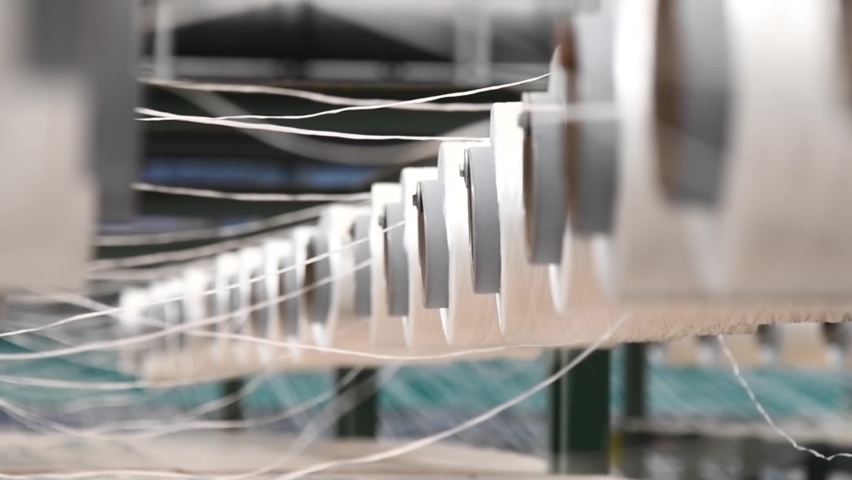 Textile industry - yarn spools on spinning machine in a textile factory | Shutterstock HD Video #1070087095