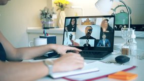 Group of colleagues talking using video conference app, videocall. Work from home, COVID-19 pandemic. Laptop with online conference being carried out on it - Powered by Shutterstock - Get 15% off with code: PIKWIZARD15