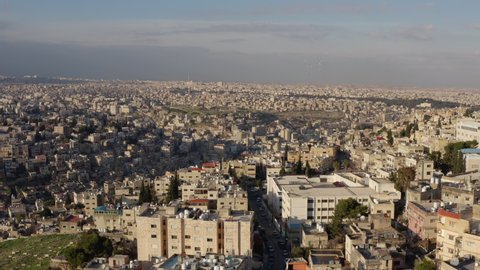 Drone video of the old Arab city. Cityscape of the Middle East with houses on the hills of historic neighborhoods and streets. Aerial view Amman Jordan.