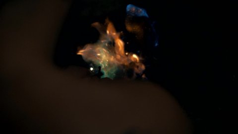 The fire flares up and burns from the flint. Close-up. Slow motion