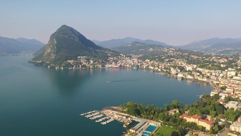 Aerial footage of the Lugano city by lake Lugano in Ticino in Switzerland