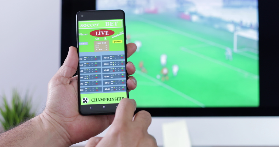 Man playing gamble on football bet application at smartphone | Shutterstock HD Video #1070122189