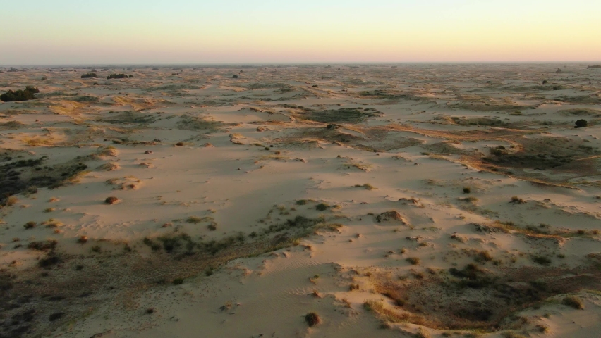 Beautiful landscape of the most bigger desert in Europe. Aerial view, 4k. Sand and little flora on it. Tourism place in Ukraine, Kherson. Oleshky Sands. Royalty-Free Stock Footage #1070125735
