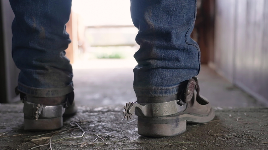 Cowboy boots with spurs walk towards barn exit 4K | Shutterstock HD Video #1070127166
