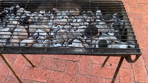 Barbecue braai hot charcoal briquettes turning grey ready to braai meat