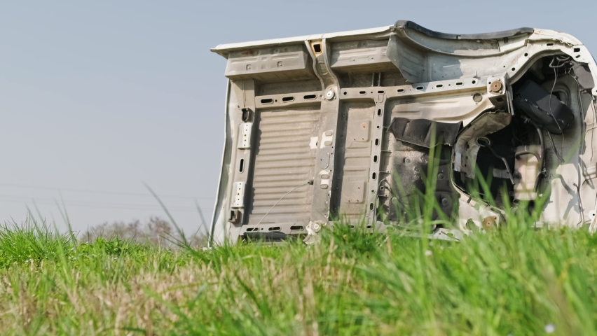 White Cabin Of A Broken And Abandoned Van In The Grass Field On A Sunny Day - medium, slider right