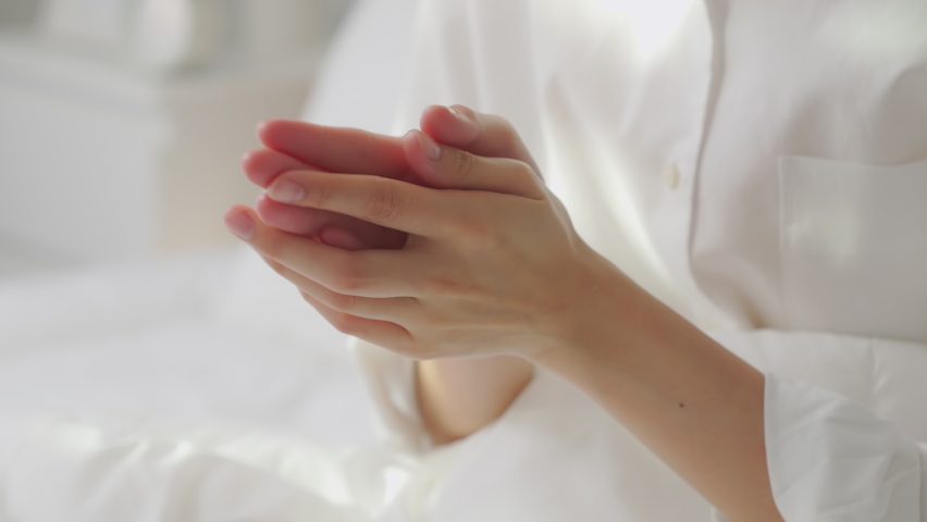 Close up of woman hand holding and applying moisturiser, Body lotion in bedroom. | Shutterstock HD Video #1070137090