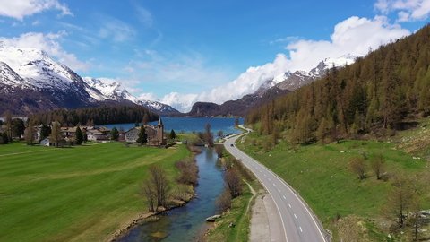 Dramatic aerial footage of lake Sils near Silvaplana in the Engadine valley in Canton Graubunden in the alps in Switzerland on a sunny summer day. 