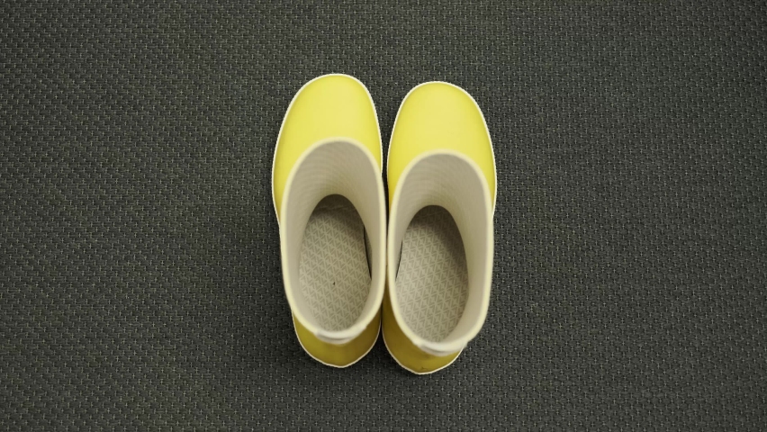 Picking Up Yellow Rubber Boots from the Hallway Floor