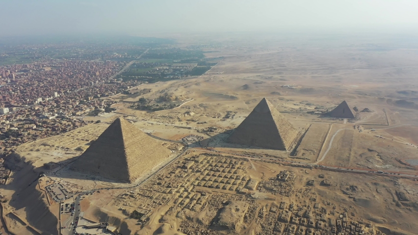 Aerial Panning to the Right shot of 3 pyramids and desert in Giza, Egypt Royalty-Free Stock Footage #1070152309