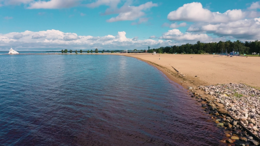 Aerial drone view low over the Nallikari beach, summer day, in Oulu, Finland