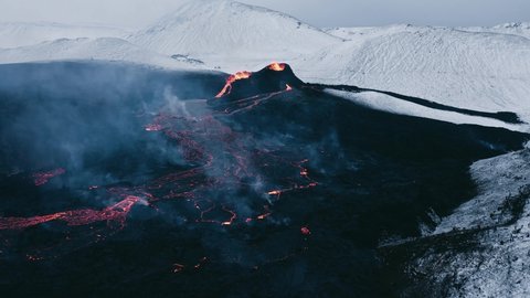 Steam rises from lava field on dark surface in remote Iceland landscape, aerial
