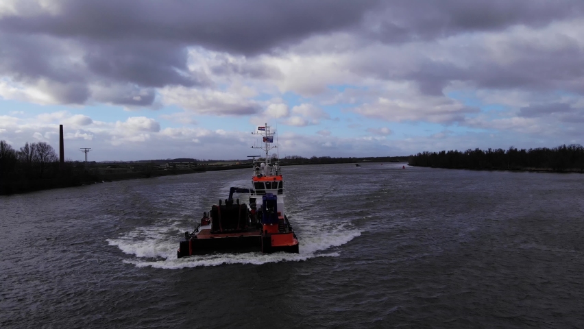 Workboat At Oude Maas River In Puttershoek, Netherlands On A Cloudy Day. wide shot