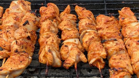 Barbecue braai marinated chicken kebabs grilling over hot coals