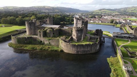 Birds fly by picturesque Caerphilly Castle in Wales aerial view