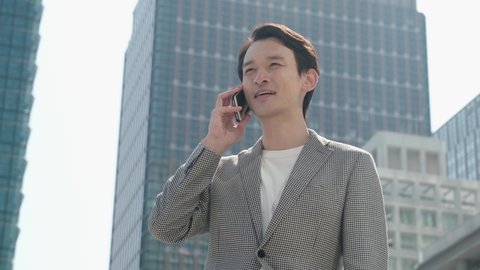 Young Japanese businessman making a phone call