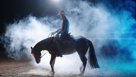 Cowboy spin with horse in night smoke backlight 4K