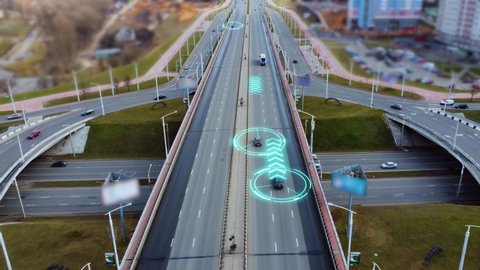 Autonomous Self Driving Cars Moving Through City Highway. Speed and identity Control System. Future transportation. Artificial Intelligence Digitalizes and Analyzes Road. Shot from drone.