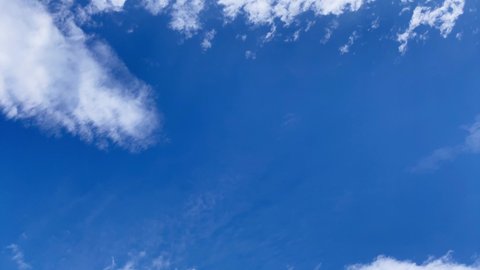 Time-lapse footage of clouds in the blue sky drifting and spreading, then dissipate. Altocumulus cloud. Cloudscape. Japan.