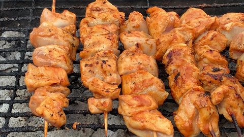 Barbecue braai chicken kebabs grilled over hot coals