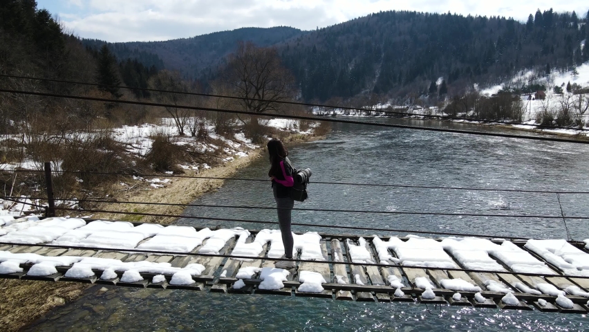 Young Asian Girl With Backpack Walking On Wooden Bridge. Tourism And Travel