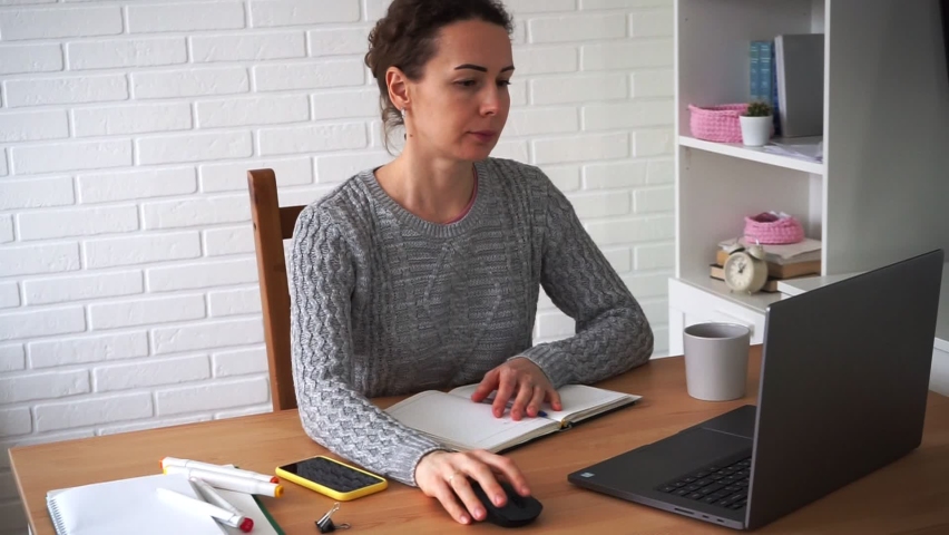 Young freelance student using laptop exploring online work from home on the internet, focused millennial woman typing on computer, pulp training, work outside the office Royalty-Free Stock Footage #1070177599