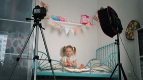 Adorable Little Girl Blogger Recording Video about Crafting Using Camera on Tripod and Professional Lighting Equipment at Home. Social Media Influence People, Content Maker, Streaming Online Podcast