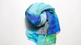 Stop motion animation. A long rolled-up blue nylon scarf moves across the surface. Top view. - Powered by Shutterstock - Get 15% off with code: PIKWIZARD15