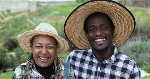 African farmers smiling on camera during harvest period - Farm lifestyle concept 