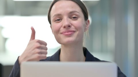Close Up of Young Businesswoman using Laptop with Thumbs Up Sign 