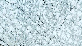 Aerial fly over view of cracked ice in the sea. Beautiful abstract pattern. Forward camera movement. 4k footage. - Powered by Shutterstock - Get 15% off with code: PIKWIZARD15