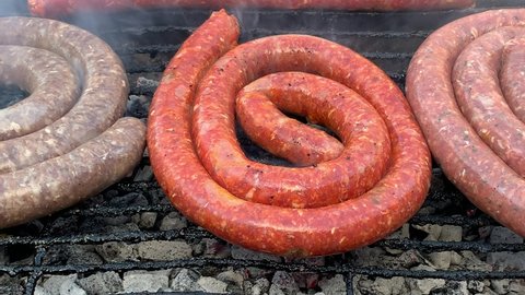 Barbecue braai sausages over hot smoking coals