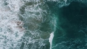 Aerial view Nature video. Powerful stormy sea waves in top-down drone shot perspective. Crashing wave line in Phuket South of Thailand. Andaman sea with foamy white texture. Nature and travel concept.