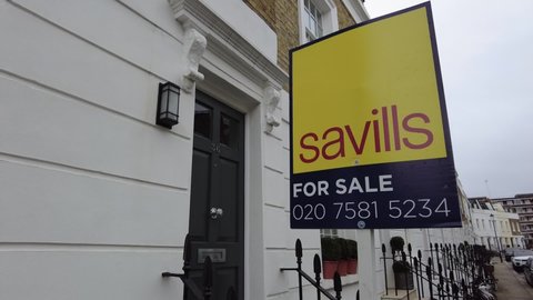 LONDON- March 2021: Savills estate agent signs advertising property in Knightsbridge London 