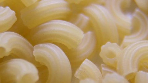 Top view of raw fresh pasta rotated on a tray. Traditional Italian cuisine. Pasta from durum wheat.