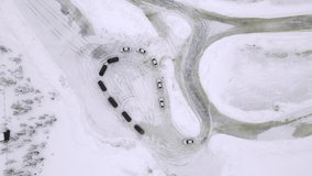 Drone Aerial view of training circuit on frozen lake with sport cars training on it before competition. Extreme diving lessons. 
